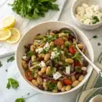 Mediterranean dense bean salad in white bowl